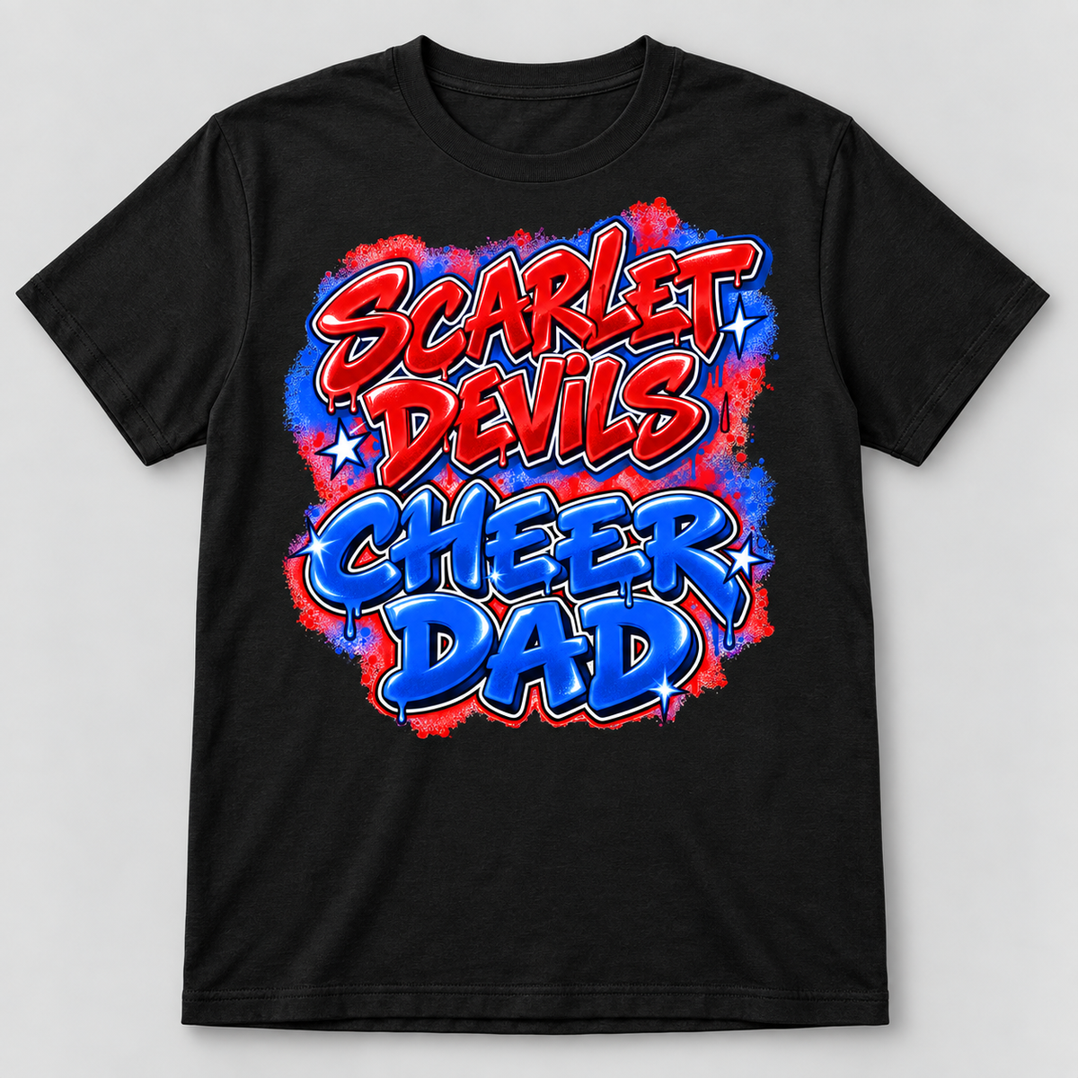 A black short-sleeve crewneck t-shirt featuring a colorful graphic print on the front that reads 'SCARLET DEVILS CHEER DAD' in red and blue graffiti-style lettering with a paint-splatter background.